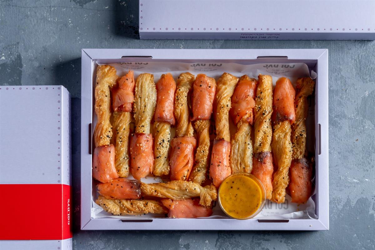 A tray of smoked salmon grissini sticks with Dijon dressing
