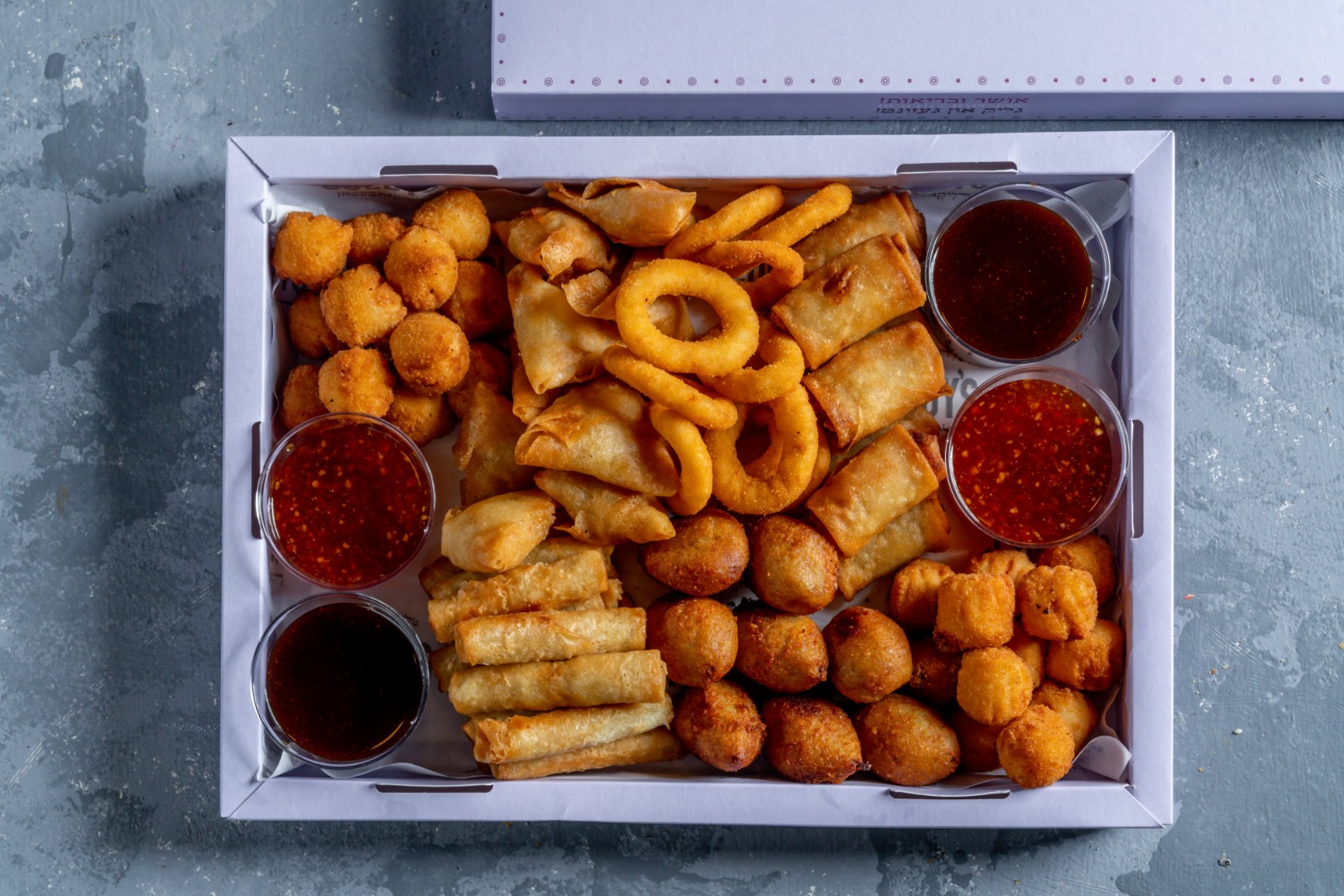 A tray of fried dumplings + condiments