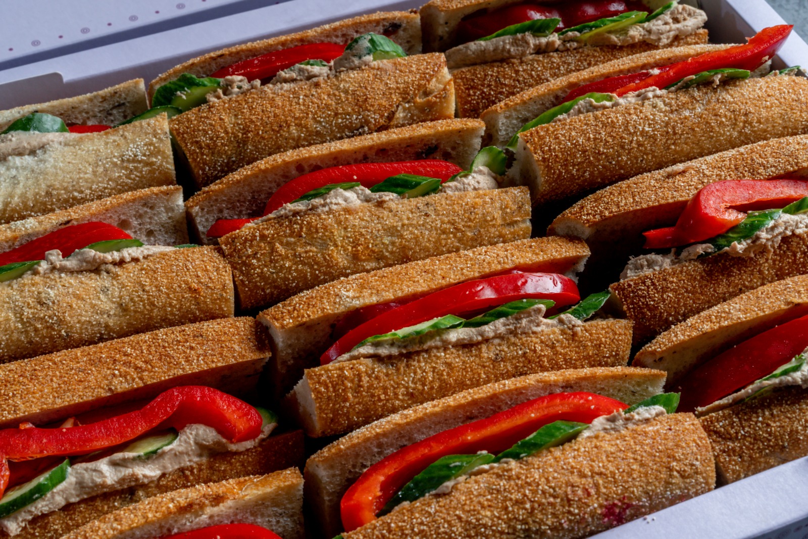 A tray of tuna sandwiches in Kalamata flute bread