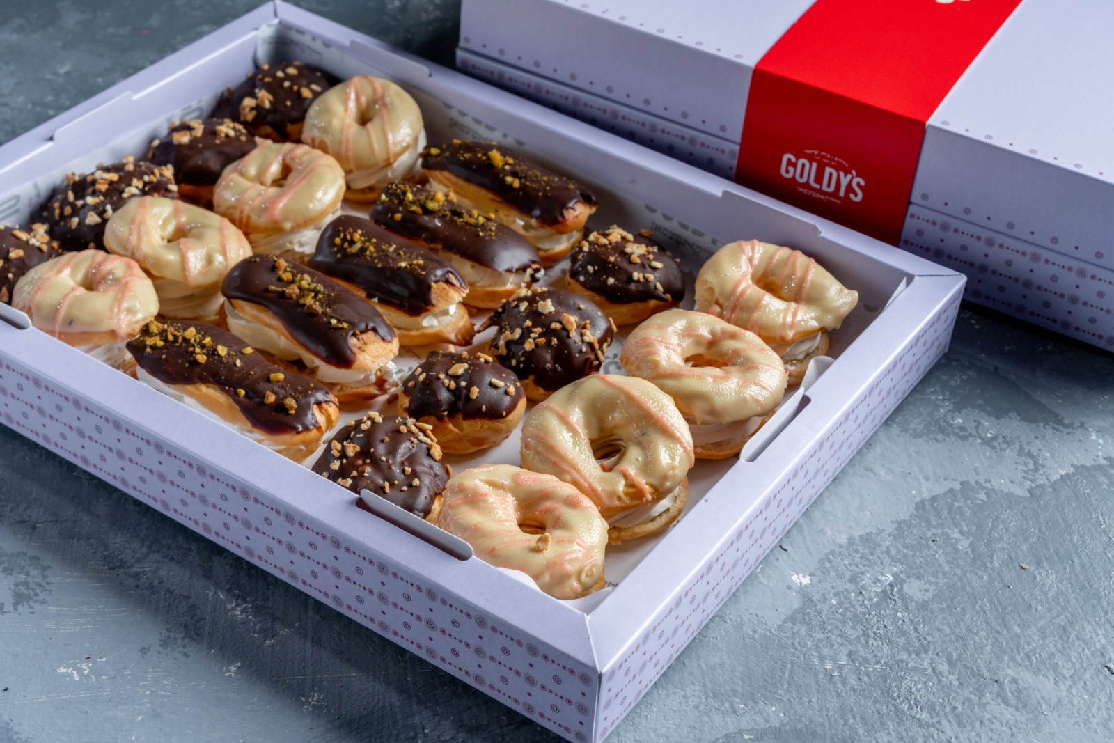 A mixed tray of eclairs and puffs